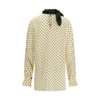 Valentino Garavani beige silk blouse with elegant draping and classic collar, displayed on a hanger.