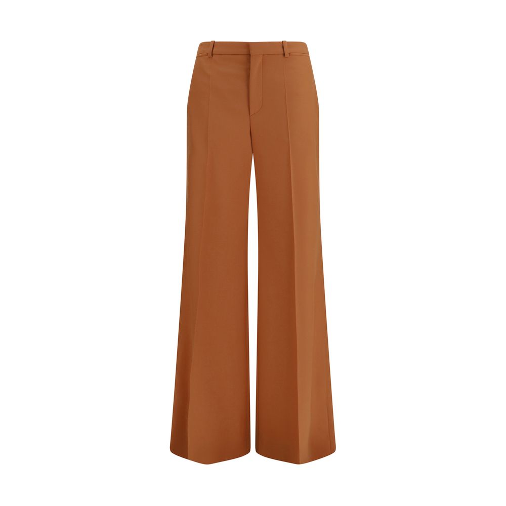 Chloé orange cotton flared pants displayed on a model, featuring a high waist and wide-leg design.