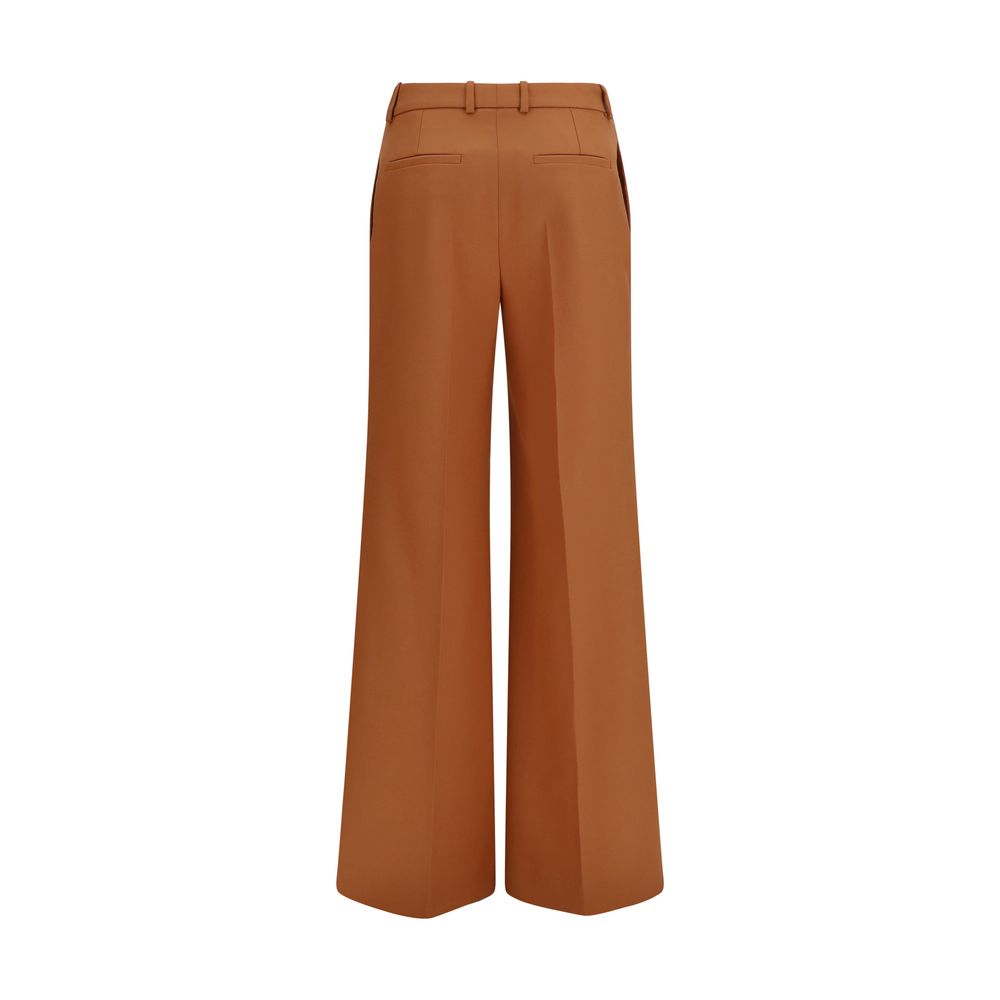 Chloé orange cotton flared pants with high waist and wide leg silhouette, displayed on a neutral background.