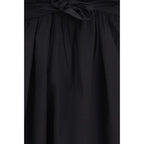 Black cotton casual dress by Ganni displayed on a hanger, featuring a relaxed fit and simple design.