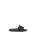 Valentino Garavani black rubber flat sandals with open toe design and adjustable ankle straps.