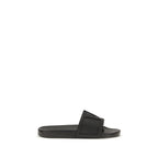 Valentino Garavani black rubber flat sandals with open toe design and adjustable ankle straps.