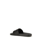 Valentino Garavani black rubber flat sandals with open toes and adjustable straps, casual summer footwear.