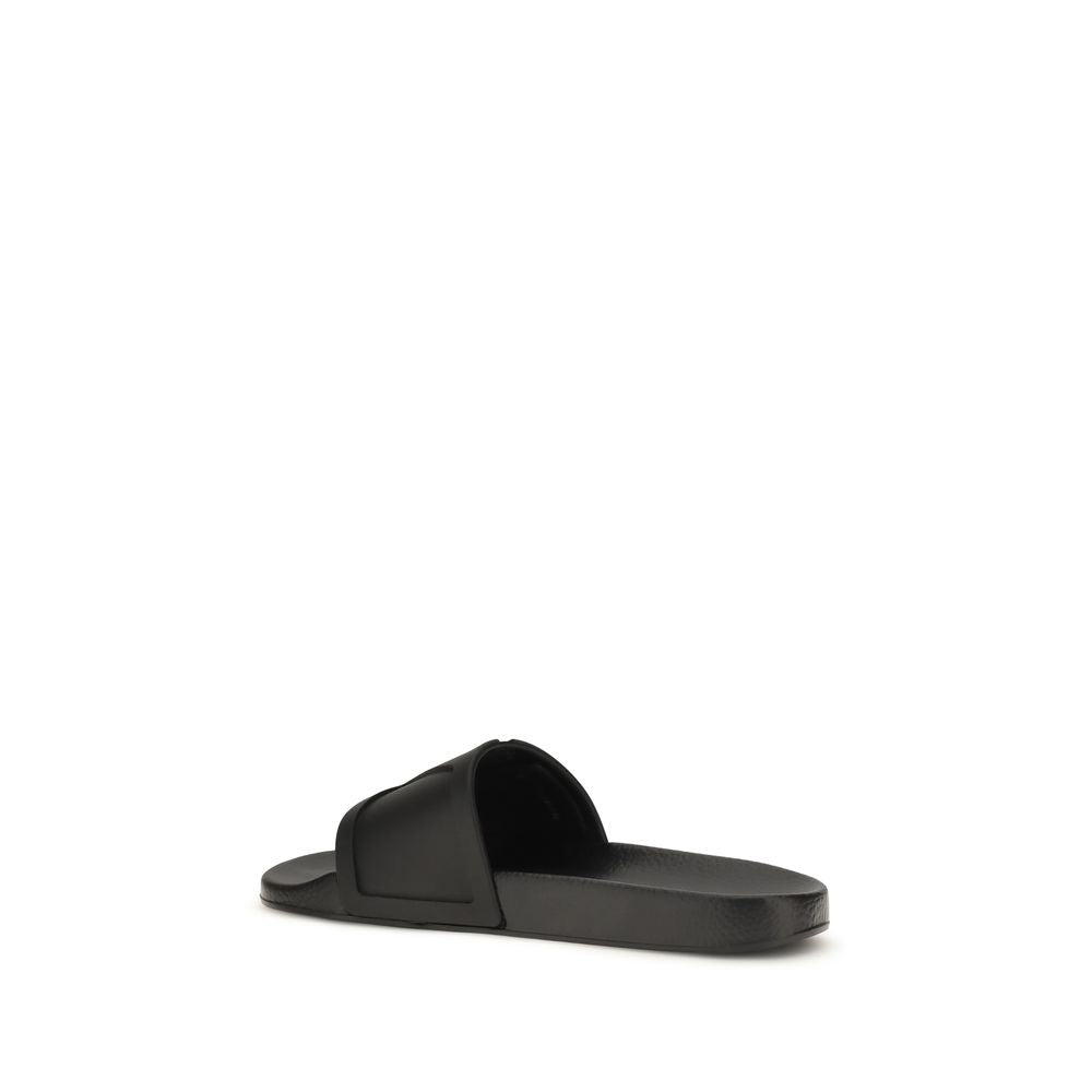 Valentino Garavani black rubber flat sandals with open toes and adjustable straps, casual summer footwear.