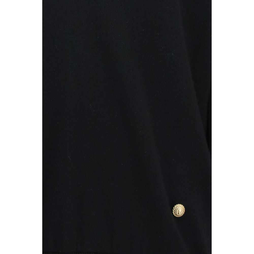 Balmain black wool oversized Aries sweatshirt with ribbed cuffs and neckline, displayed on a hanger.