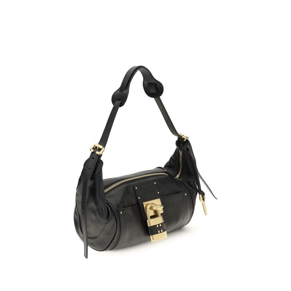 Chloé black calf leather Bos Taurus shoulder bag with sleek design and gold-tone hardware, featuring a top handle and adjustable strap.