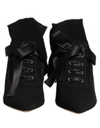 Dolce & Gabbana black stiletto heels with mid-calf boot design, featuring sleek leather and elegant silhouette.