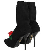 Dolce & Gabbana black stiletto heels with mid-calf boots, sleek leather shoes with pointed toes and high heels.