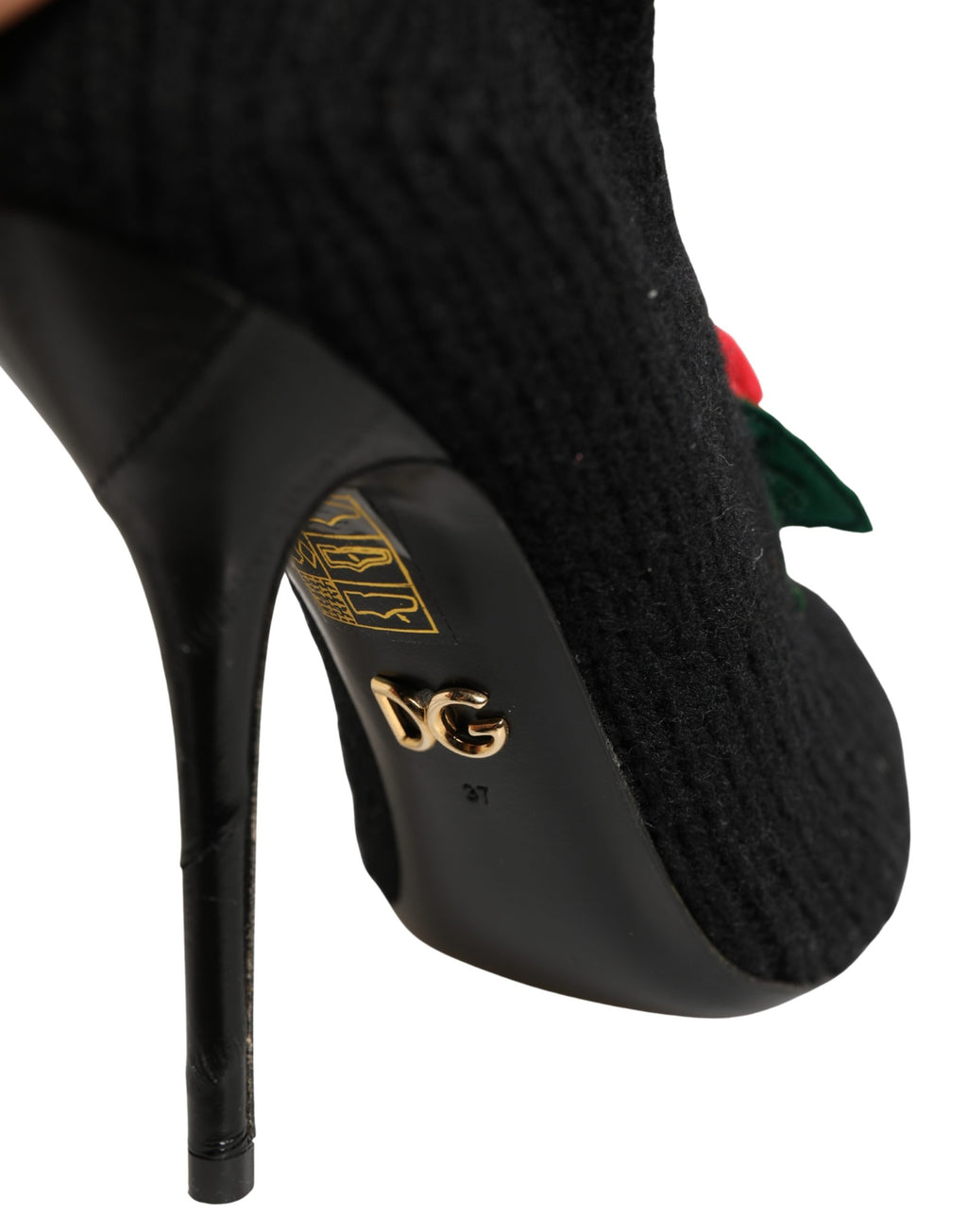 Black Dolce & Gabbana stiletto heels with mid-calf boot design, featuring sleek leather and elegant pointed toes.