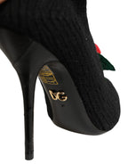 Black Dolce & Gabbana stiletto heels with mid-calf boot design, featuring sleek leather and elegant pointed toes.