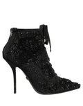 Black embellished mesh ankle boots by Dolce & Gabbana showing pointed toes and decorative details on the shoes.