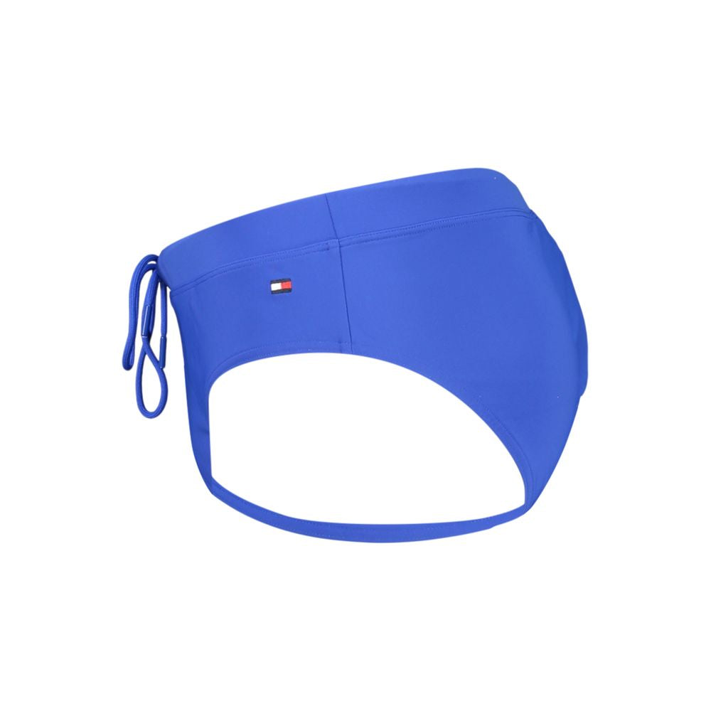 Tommy Hilfiger men's blue polyester swimwear swim trunks with logo waistband and drawstring, front view showing fit and fabric detail.