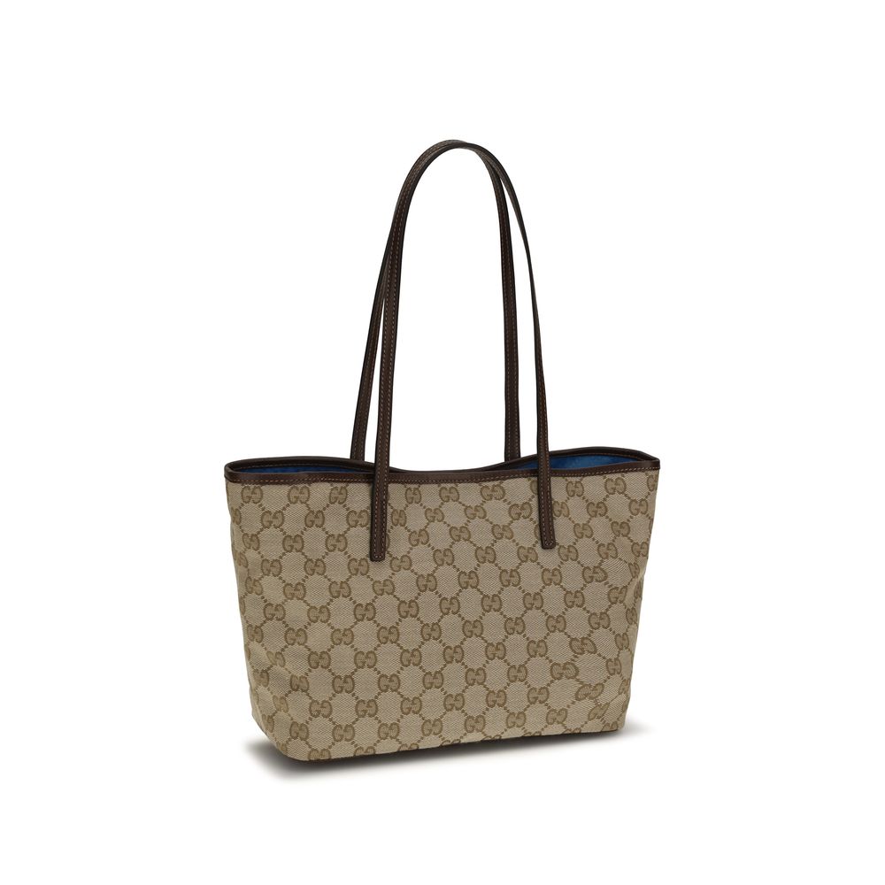 Gucci beige fabric handbag with structured design, featuring leather accents and gold-tone hardware for a stylish look.
