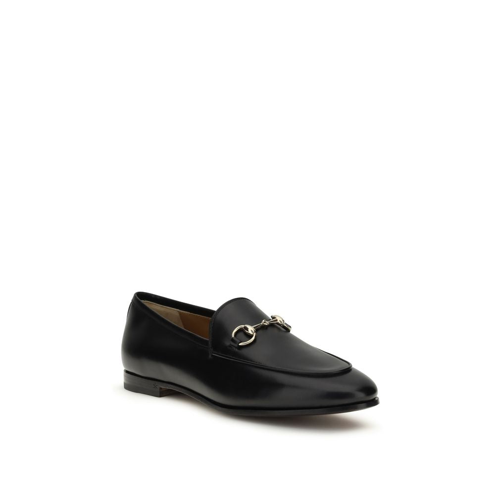 Gucci black calf leather Bos Taurus slip-on loafers showing sleek design and smooth leather finish.