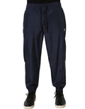 Dark blue Dolce & Gabbana polyester jogger sweatpants with elastic waistband and tapered fit, shown on a model.