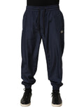 Dark blue Dolce & Gabbana polyester jogger sweatpants with elastic waistband and cuffed ankles, shown on a plain background.