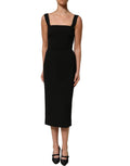 Dolce & Gabbana black viscose stretch sheath midi dress displayed on a mannequin with a fitted silhouette and elegant design.