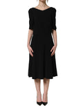 Black Dolce & Gabbana viscose short sleeve A-line midi dress displayed on a mannequin, showcasing a stylish, elegant design.