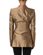 Dolce & Gabbana gold silk double-breasted coat blazer jacket shown on a hanger with detailed lapels and tailored fit.