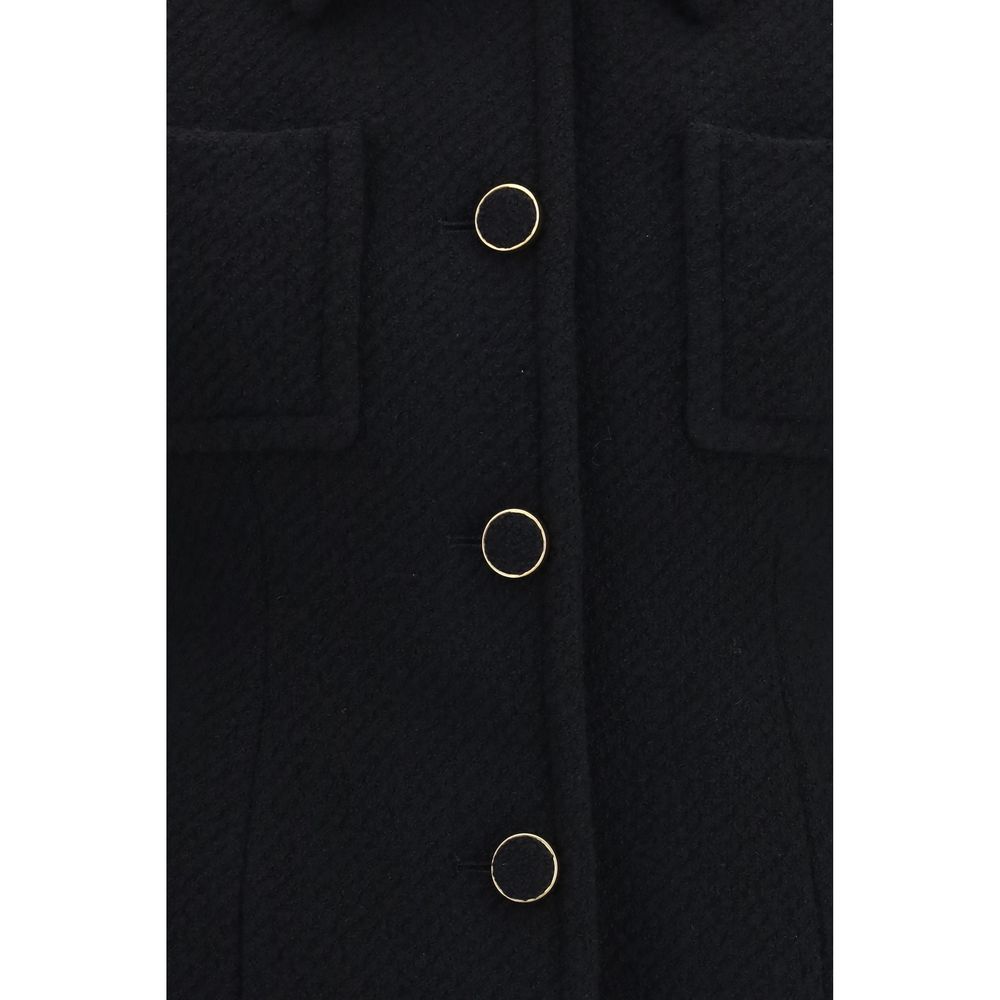 Chloé black wool Aries blazer with tailored fit and lapel collar, displayed on a hanger against a neutral background.