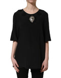 Dolce & Gabbana black floral silk blouse with heart appliqué, featuring long sleeves and elegant design.