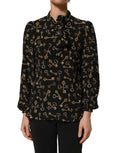 Dolce & Gabbana black silk blouse with keys print, featuring a tie-neck design and long sleeves, elegant and stylish for formal wear.