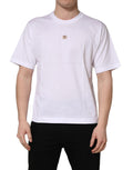White cotton short sleeve T-shirt by Dolce & Gabbana with metal DG logo on the chest, featuring a classic crew neck design.