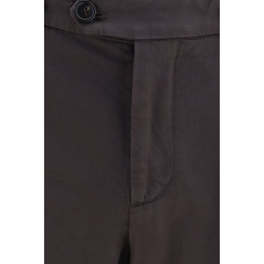 Brown cotton casual pants by Brunello Cucinelli displayed on a model, showcasing a relaxed fit and sophisticated style.