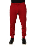 Red Dolce & Gabbana cotton jogger pants with DG logo, men's sweatpants featuring an elastic waistband and tapered fit.