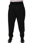 Black pinstripe wool men's dress trousers by Dolce & Gabbana, tailored fit with classic waistband and front pockets.