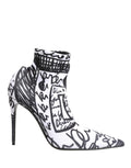 White Dolce & Gabbana graffiti-stretch ankle boots with a sleek, modern design and pointed toes, showcasing stylish footwear details.