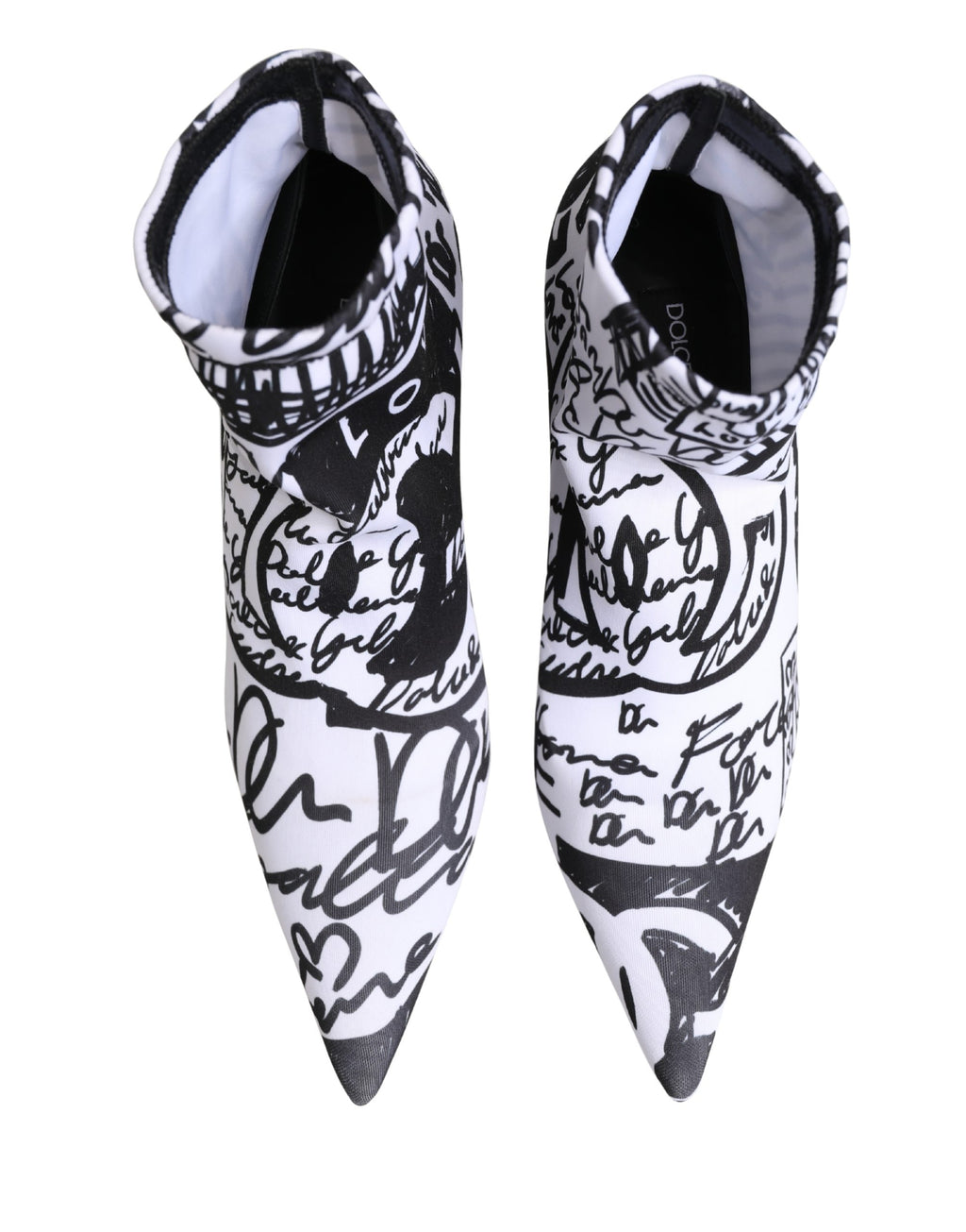Dolce & Gabbana white graffiti stretch ankle boots with bold graffiti design, pointed toe, and sleek silhouette.