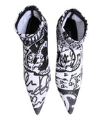 Dolce & Gabbana white graffiti stretch ankle boots with bold graffiti design, pointed toe, and sleek silhouette.