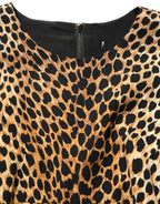 Dolce & Gabbana brown leopard print silk sheath midi dress displayed on a mannequin with a fitted silhouette and elegant style.