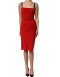 Red Dolce & Gabbana stretch bodycon sheath knee-length dress displayed on a mannequin with elegant design details.