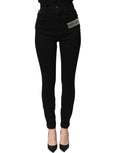 Dolce & Gabbana black high-waist denim jeans with rhinestone embellishments and a fitted silhouette.
