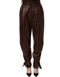 Dolce & Gabbana brown leather high waist tapered leg pants displayed on a model.