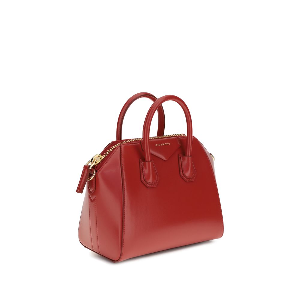 Red calf leather Givenchy Bos Taurus handbag with gold-tone hardware and structured design.