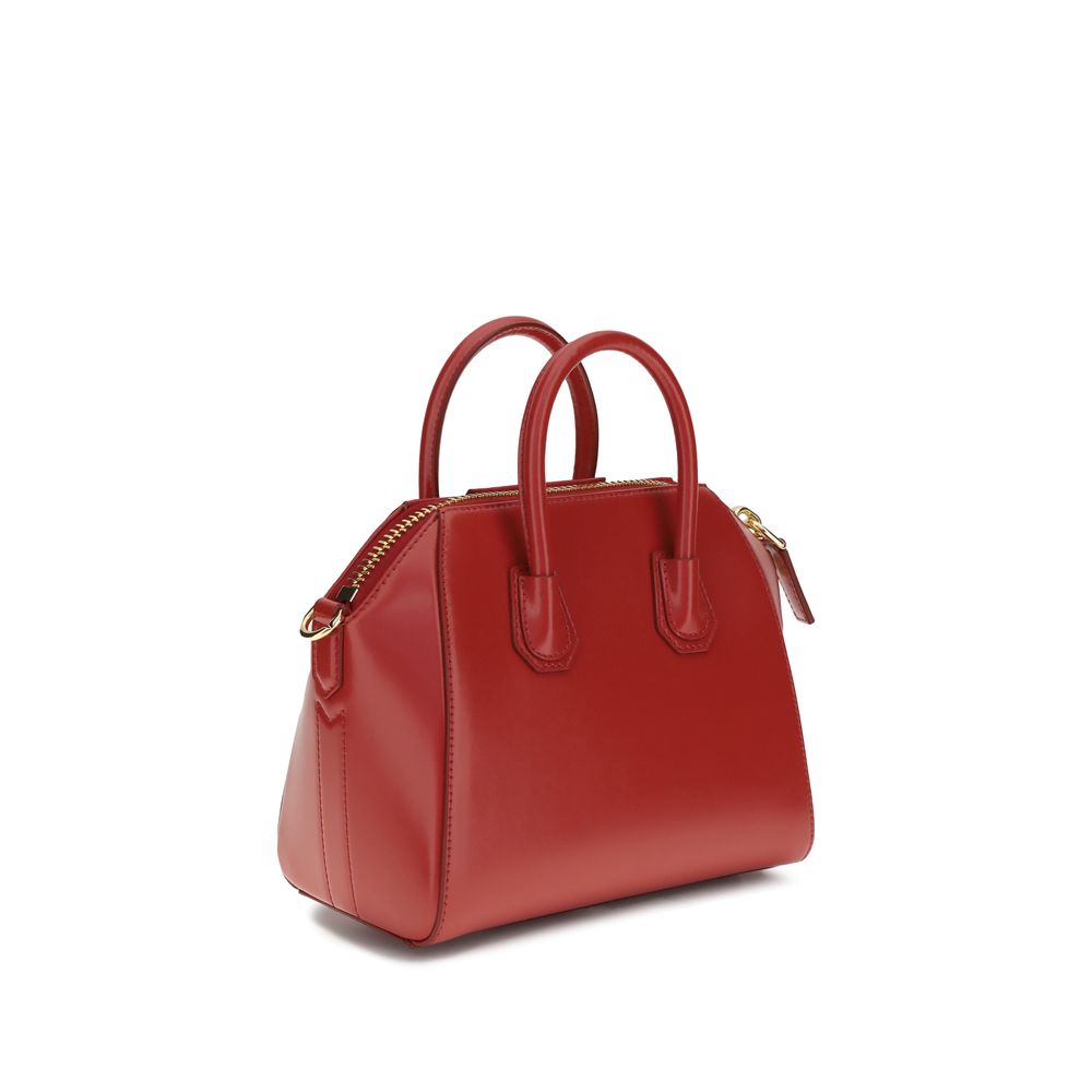 Givenchy Bos Taurus handbag made of red calf leather with silver hardware, featuring a structured design and top handle.