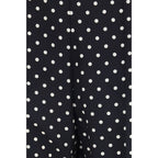 Black silk cropped pants by Valentino Garavani featuring a tailored fit and sleek style, shown on a model.