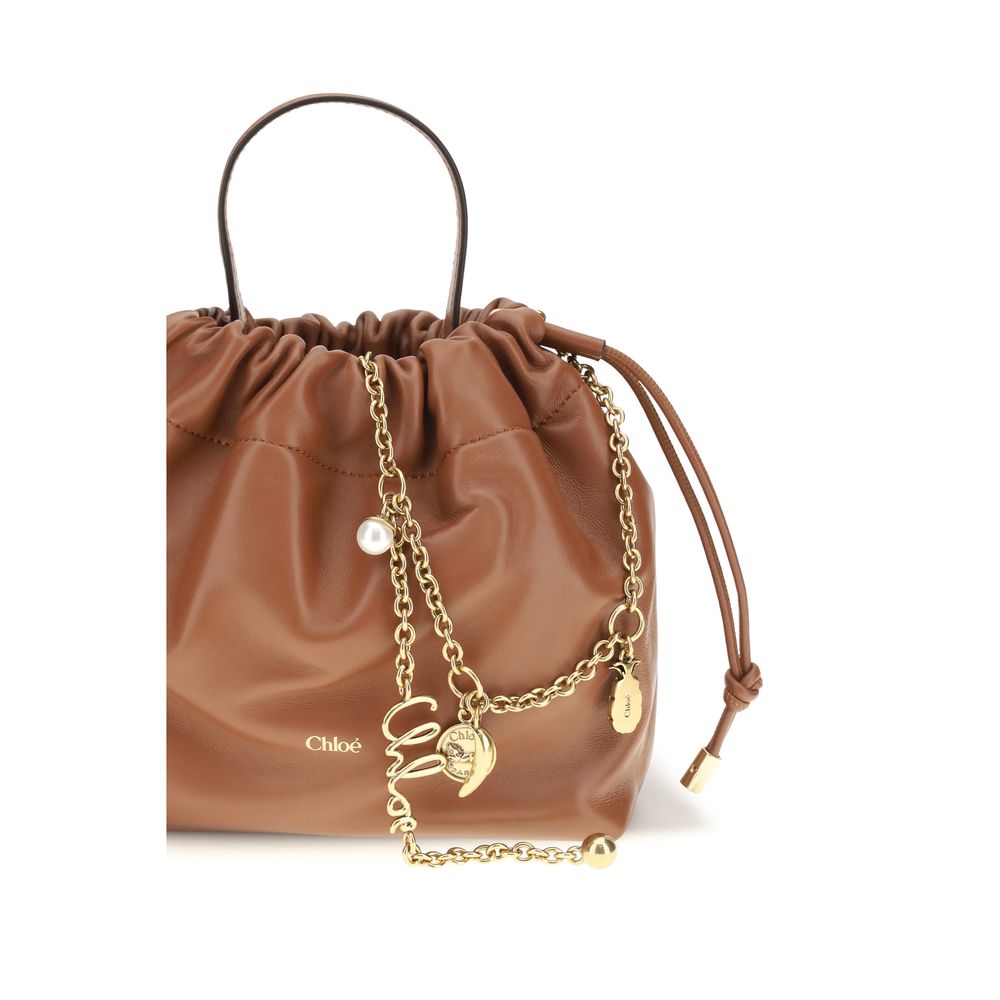 Chloé brown lamb leather shoulder bag with ovis aries detailing, featuring a sleek design and structured shape.