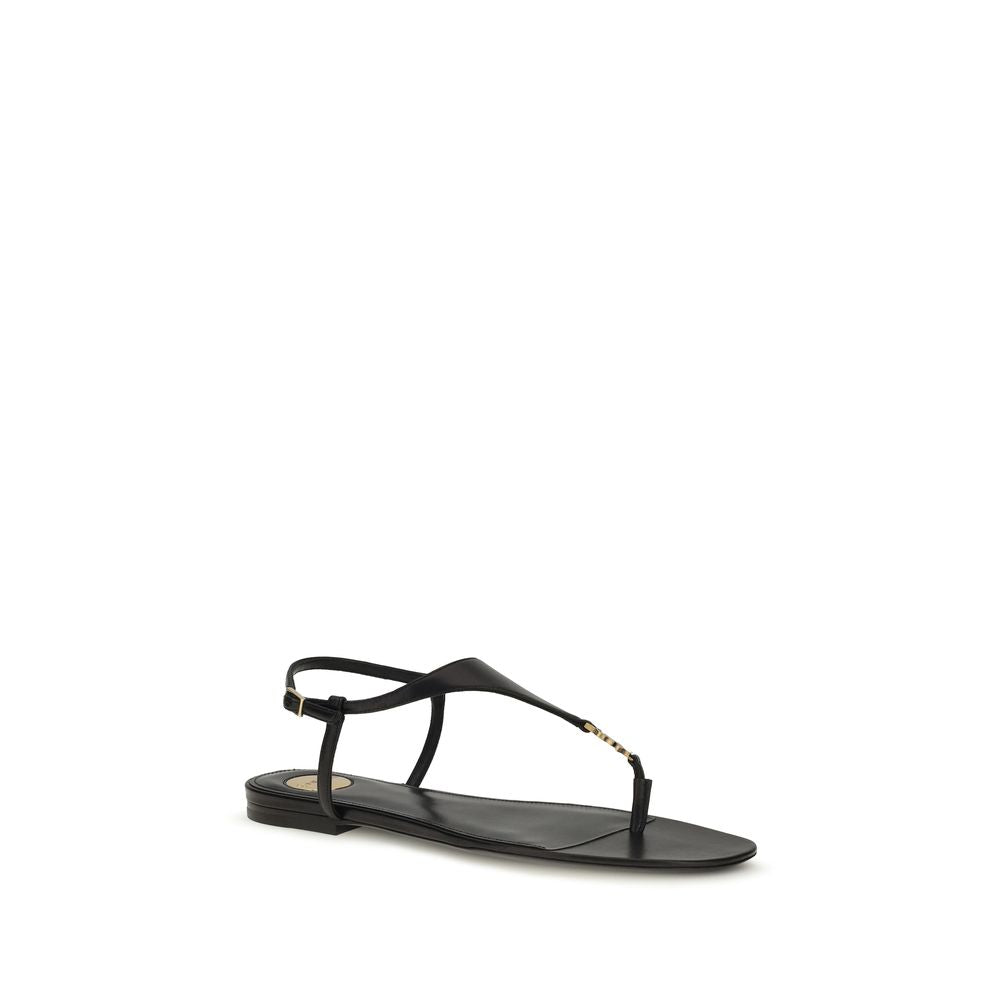 Saint Laurent black calf leather Bos Taurus flat sandals with open toe and ankle strap, featuring sleek, minimalist design.