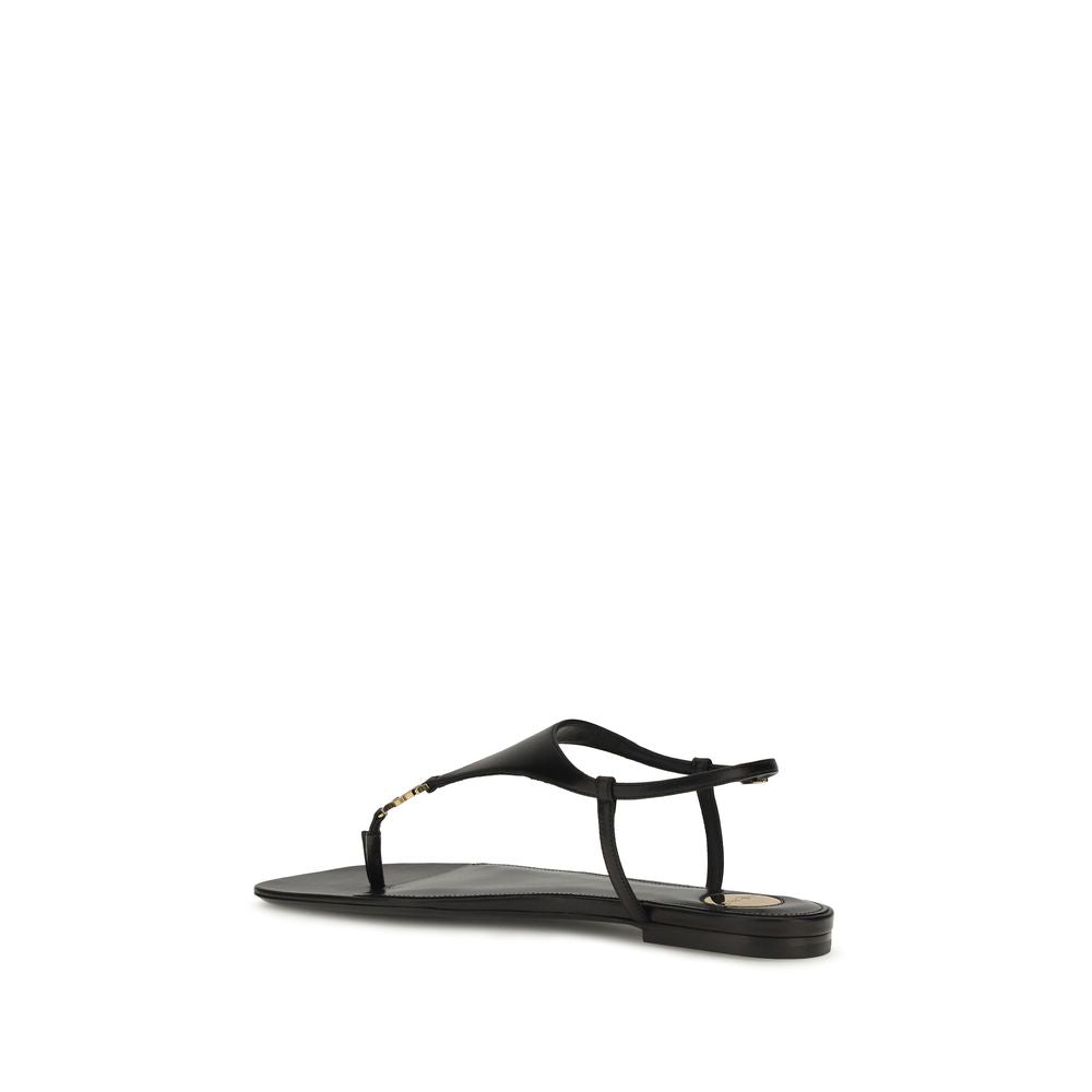 Saint Laurent Black Calf Leather Bos Taurus Flat Sandals with open toe and ankle strap, stylish and comfortable for warm weather.