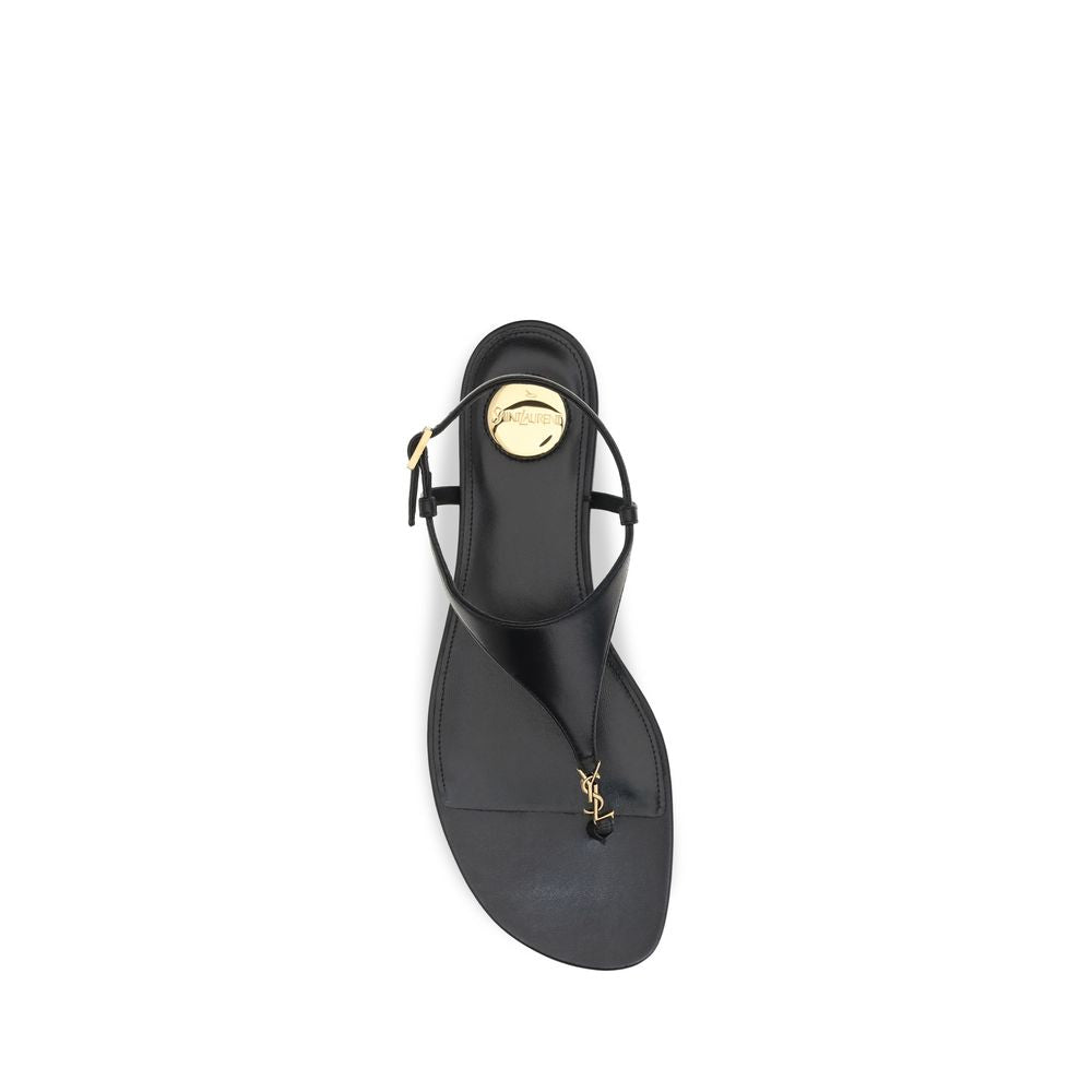Saint Laurent black calf leather Bos Taurus flat sandals with minimalist design and open toe, featuring sleek straps.