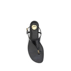 Saint Laurent black calf leather Bos Taurus flat sandals with minimalist design and open toe, featuring sleek straps.