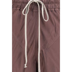 Rick Owens brown silk casual pants displayed on a hanger, showcasing their relaxed fit and smooth fabric.