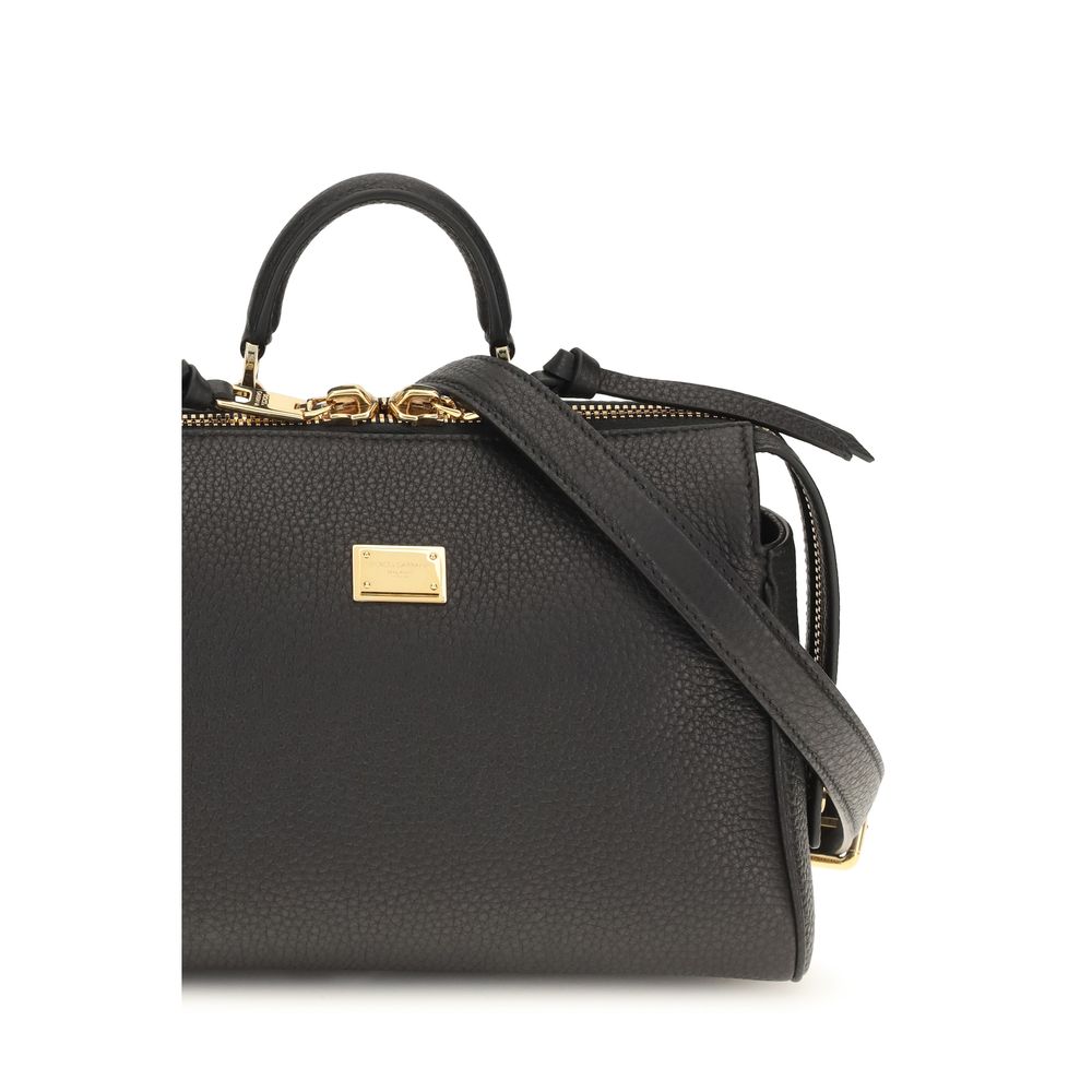 Black calf leather Dolce & Gabbana Bos Taurus handbag with gold-tone hardware and structured design.
