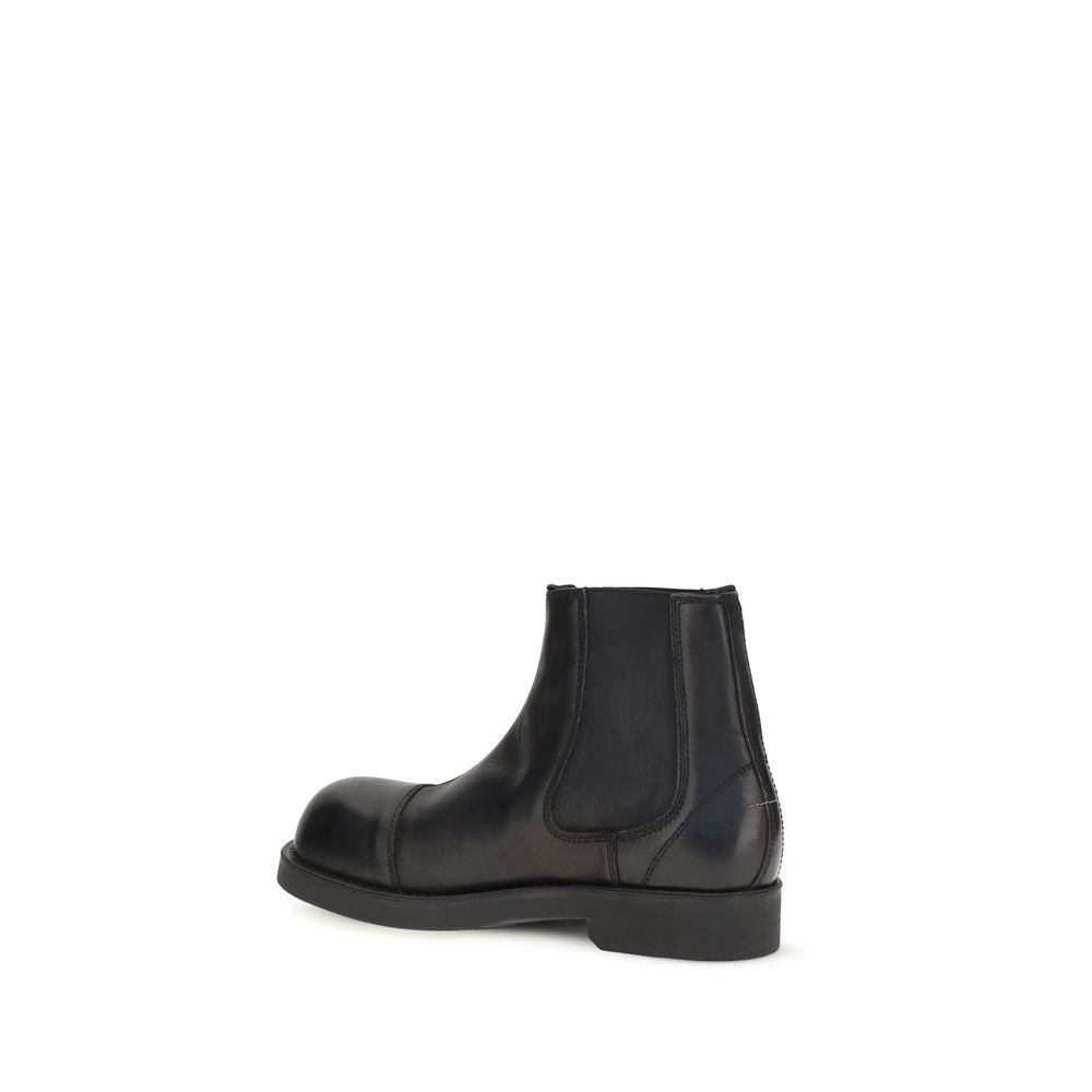 Black calf leather MM6 Bos Taurus Chelsea boots with elastic side panels and sleek design.