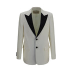 Valentino Garavani white wool blazer with over Aries design, tailored fit, and classic lapels, displayed on a hanger.