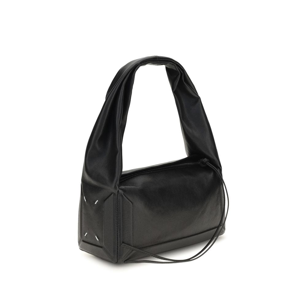 Maison Margiela black leather handbag with sleek design and structured shape, featuring subtle branding and elegant craftsmanship.